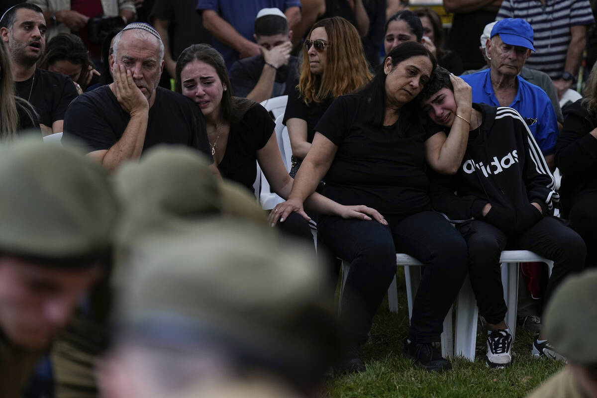 Family members of Sgt. Roni Eshel cry during her funeral in Kfar Saba, Israel, Sunday Nov. 12, ...