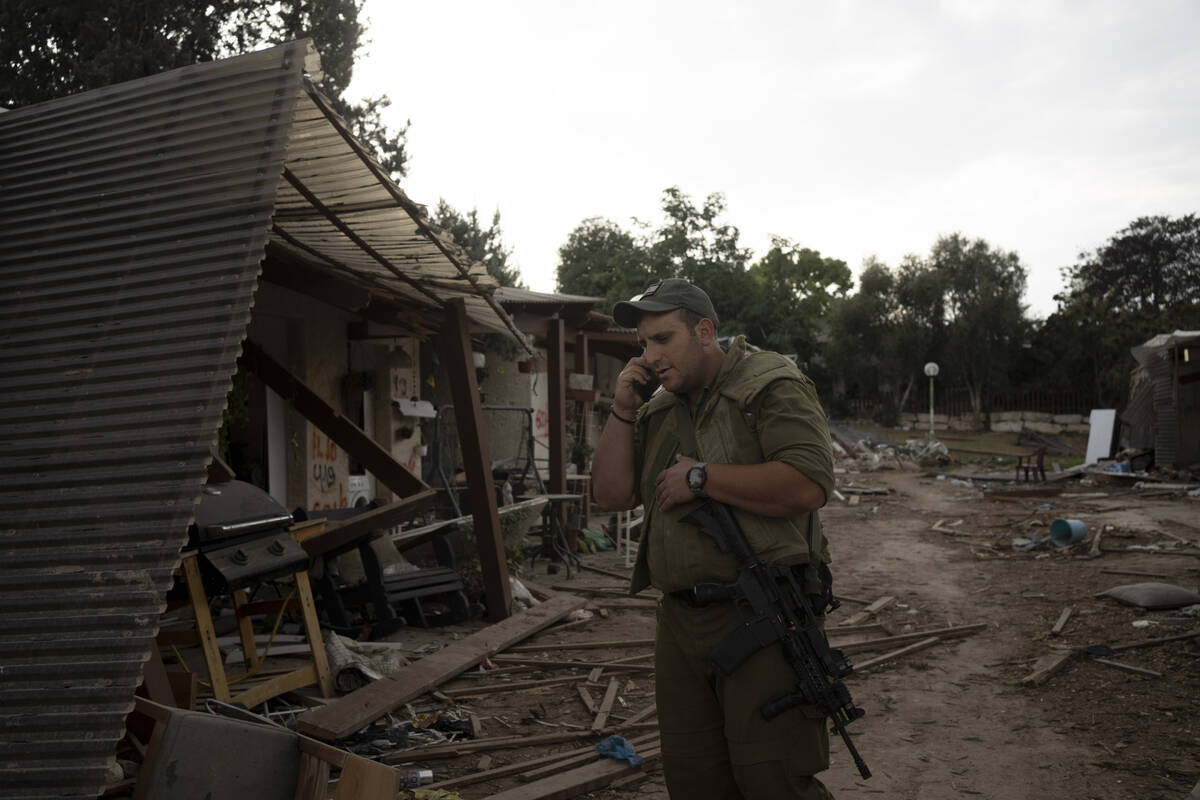 An Israeli soldier makes a call during a visit by former New Jersey Governor Chris Christie to ...