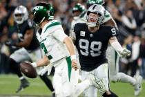 New York Jets quarterback Zach Wilson (2) is chased by Raiders defensive end Maxx Crosby (98) d ...