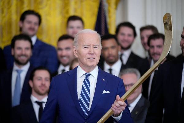 President Joe Biden speaks while holding a hockey stick during an event to celebrate the Vegas ...