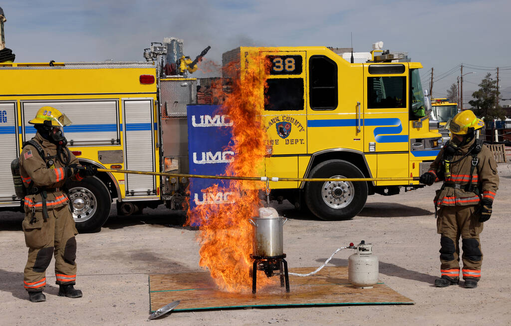 Firefighters perform a holiday cooking safety demonstration using a frozen turkey in hot oil at ...