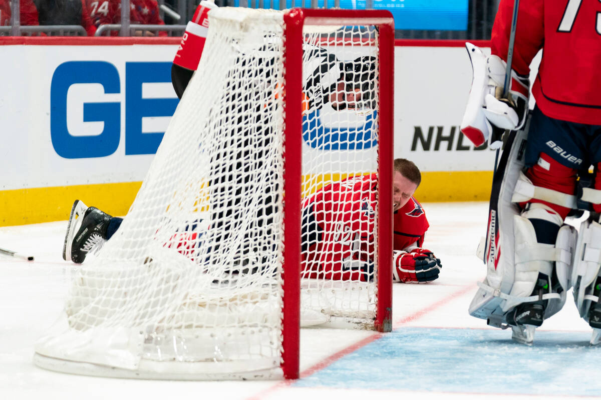 Washington Capitals center Evgeny Kuznetsov reacts after a hit to the head in the second period ...