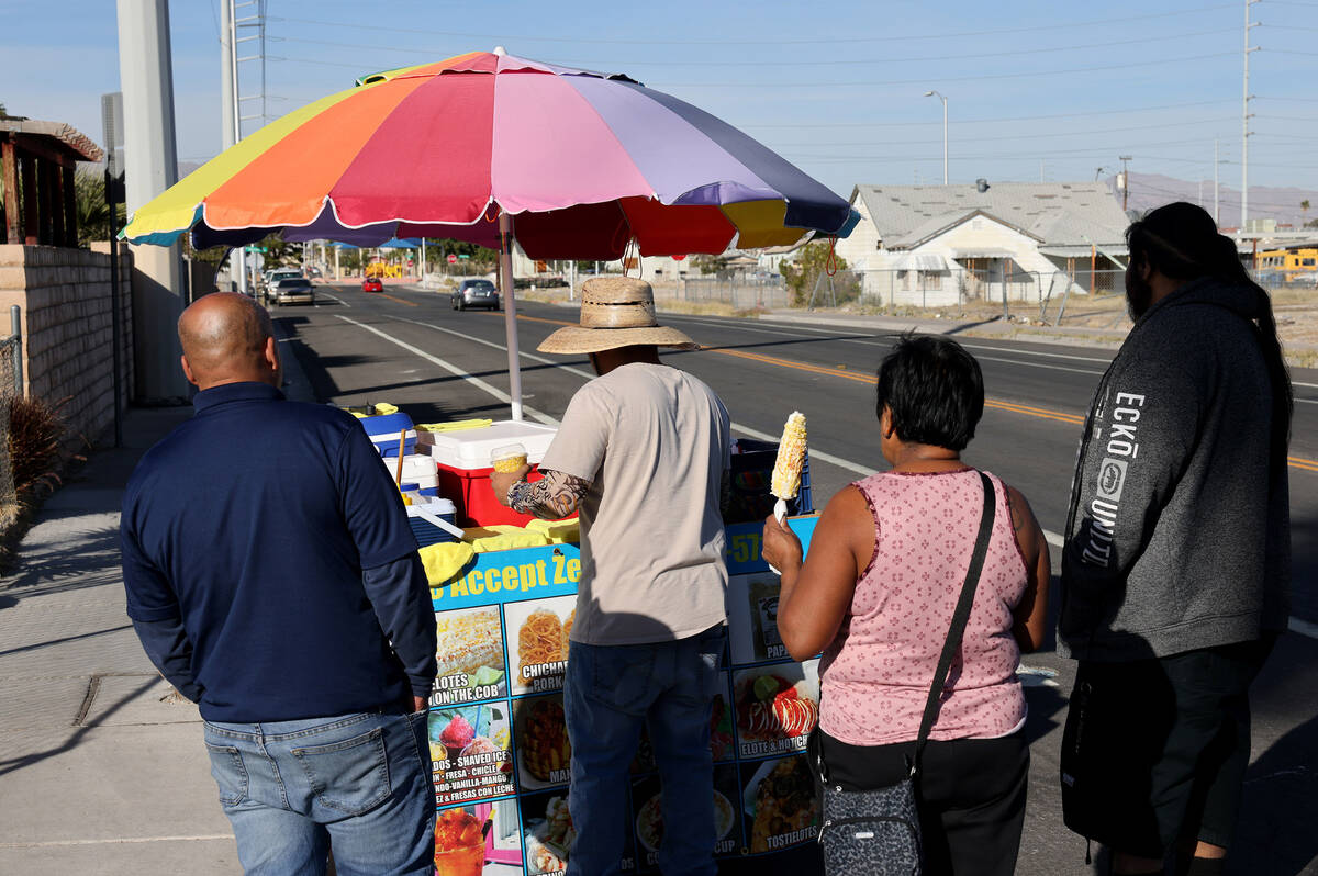 Street vendor Luis Serrano serves customers in the Historic Westside in Las Vegas Tuesday, Nov. ...