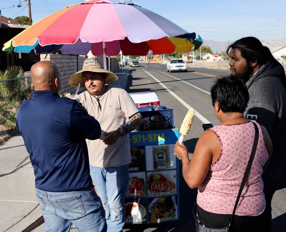 Street vendor Luis Serrano serves customers in the Historic Westside in Las Vegas Tuesday, Nov. ...