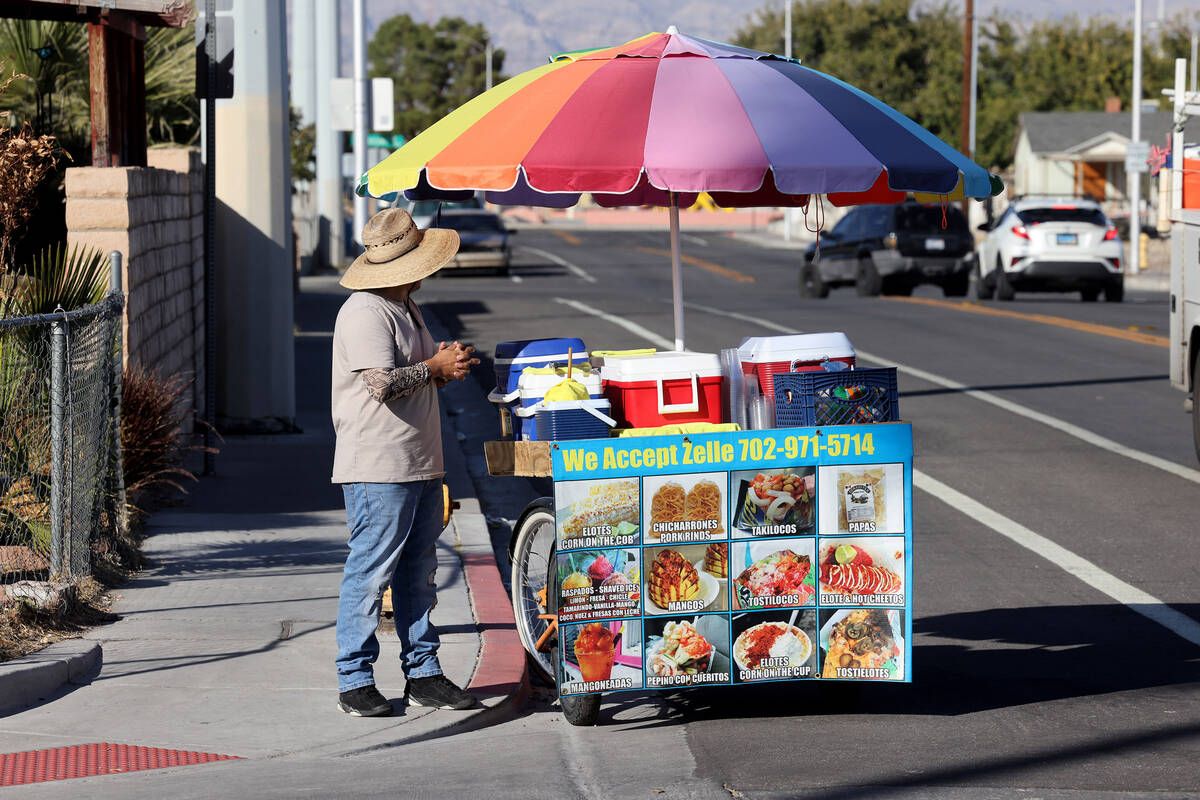 Street vendor Luis Serrano waits to serve customers in the Historic Westside in Las Vegas Tuesd ...