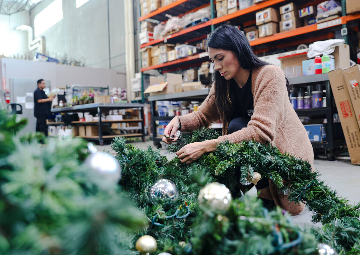 Sylvia Lopez, a survivor of addiction, disassembles a garland at her job as a florist at Destin ...