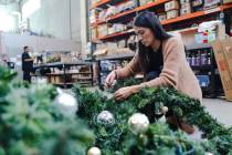 Sylvia Lopez, a survivor of addiction, disassembles a garland at her job as a florist at Destin ...