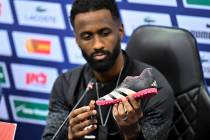 Israel team captain Eli Dasa shows a shoe of a kidnapped Israeli boy during a press conference, ...