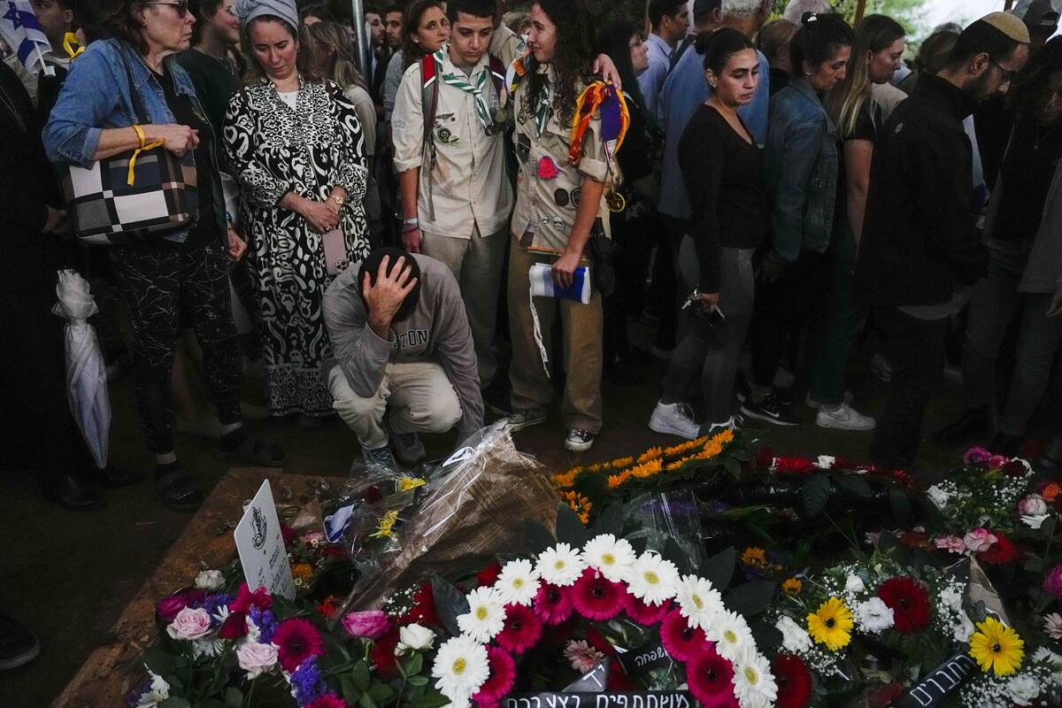 Mourners gather around the grave of Israeli reserve soldier Master sergeant Raz Abulafia at the ...