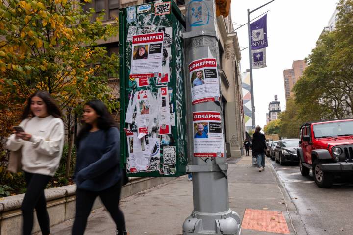 Posters of some of those kidnapped by Hamas in Israeli are displayed on a pole outside of New Y ...
