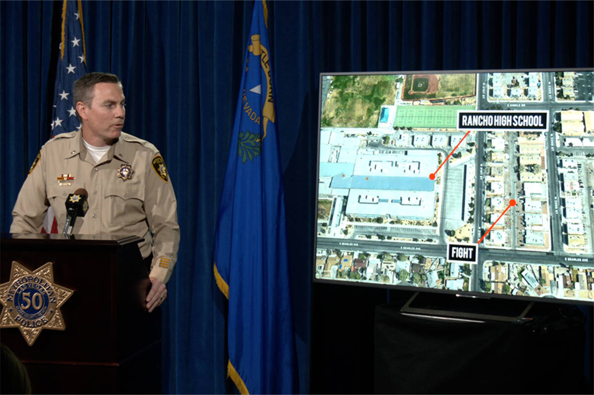 Homicide Lt. Jason Johansson looks at an aerial map of the homicide scene near Rancho High Scho ...