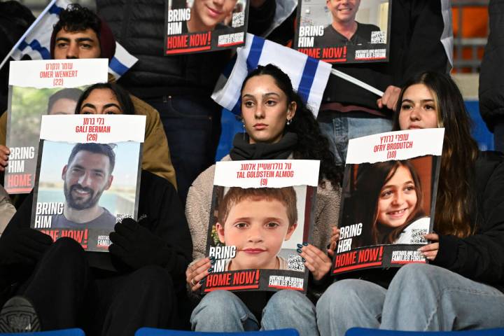 Fans of Israel hold up signs of people who were kidnapped by Hamas prior the start of the Euro ...