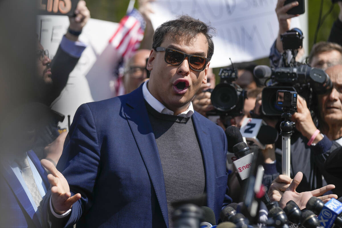 FILE - Rep. George Santos, D-N.Y., speaks to reporters as he leaves the federal courthouse in C ...