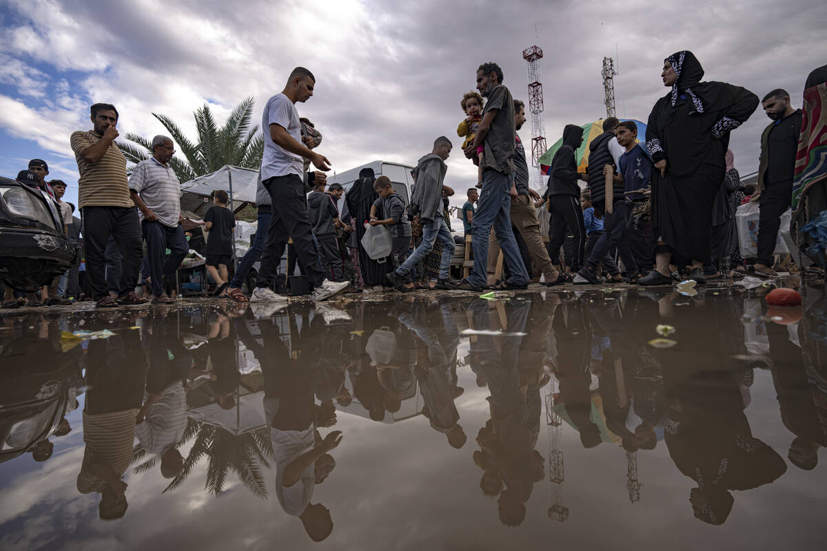 Palestinians displaced by the Israeli bombardment of the Gaza Strip walk in a UNDP-provided ten ...