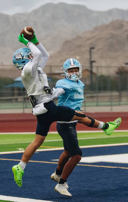 Centennial football players participate in a team practice at Centennial High School on Wednesd ...