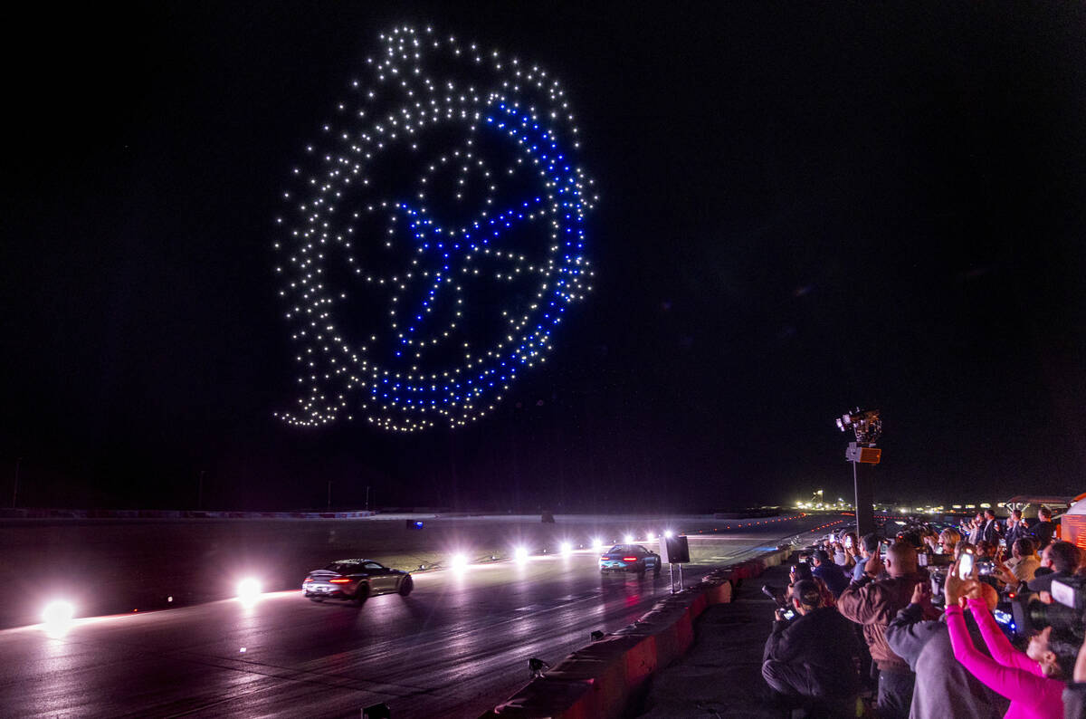 Drones form a flying timepiece as Mercedes-AMG drivers Lewis Hamilton and George Russell cruise ...