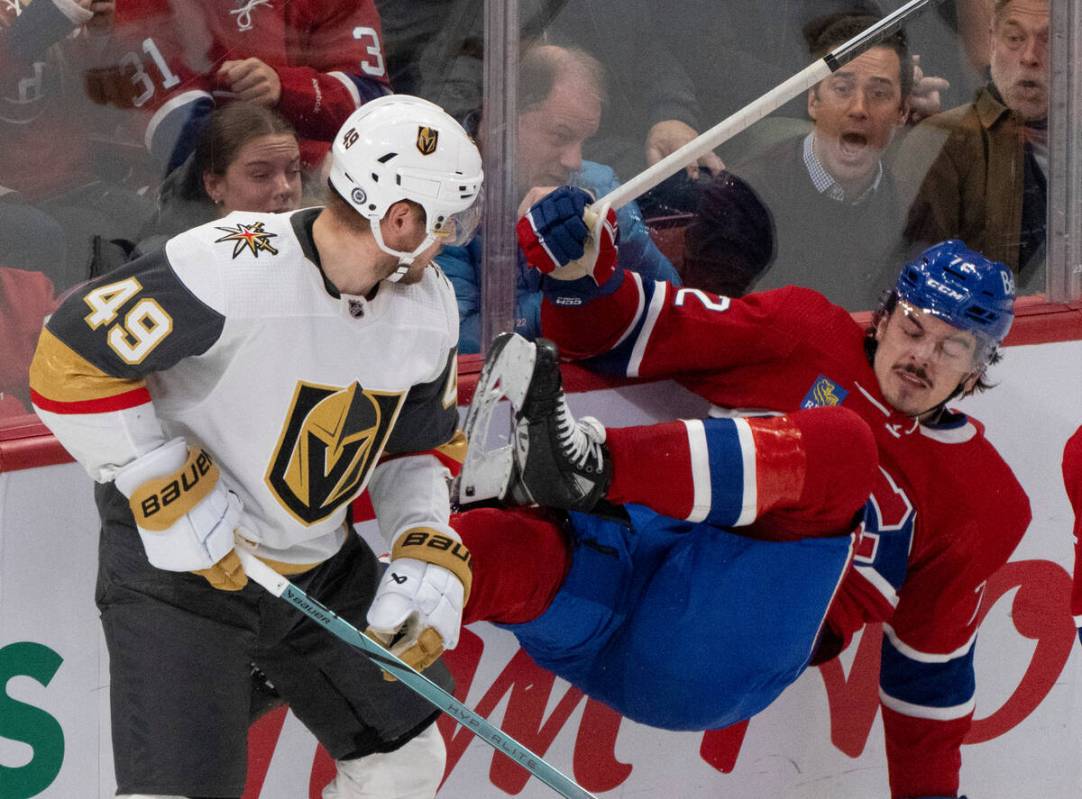 Montreal Canadiens' Arber Xhekaj (72) is checked into the boards by Vegas Golden Knights' Ivan ...