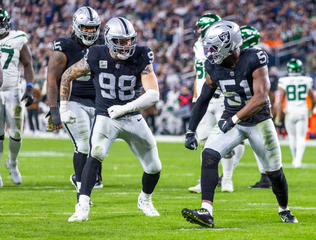 Raiders defensive end Maxx Crosby (98) and defensive end Malcolm Koonce (51) do a funny walk af ...