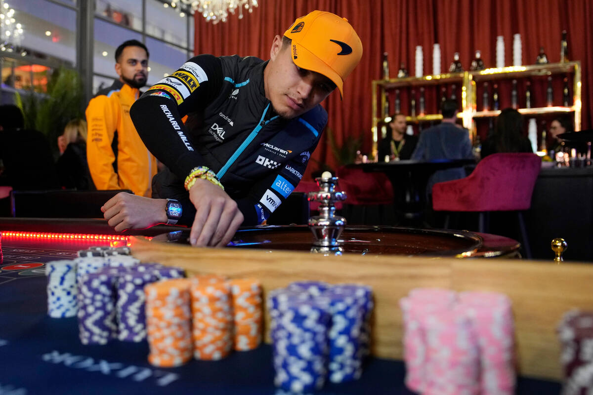 McLaren driver Lando Norris, of Britain, spins a roulette wheel before an opening ceremony for ...