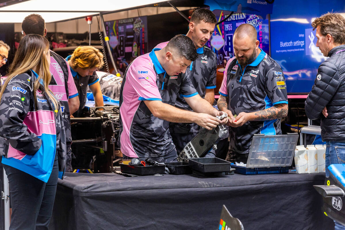 A crew from Esteban Ocon's car with BWT Alpine work to make repairs in the pit building after i ...