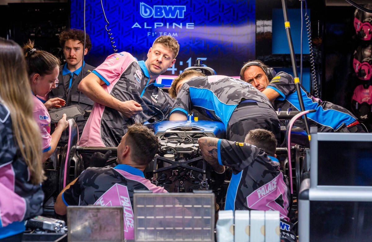 A crew from Esteban Ocon's car with BWT Alpine work to make repairs in the pit building after i ...