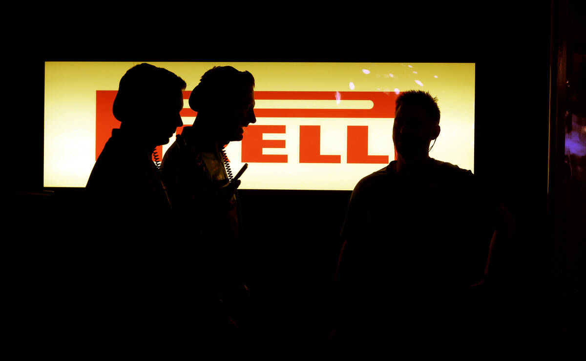 Crew members hang out in the garage area before the practice session during the opening night o ...