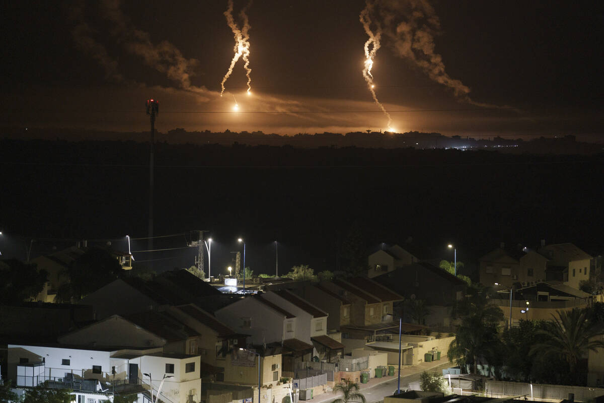 Flares rise over the Gaza Strip, as seen from southern Israel, Thursday, Nov. 16, 2023. (AP Pho ...