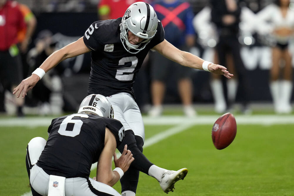 Las Vegas Raiders place kicker Daniel Carlson (2) licks a field goals as punter AJ Cole (6) hol ...