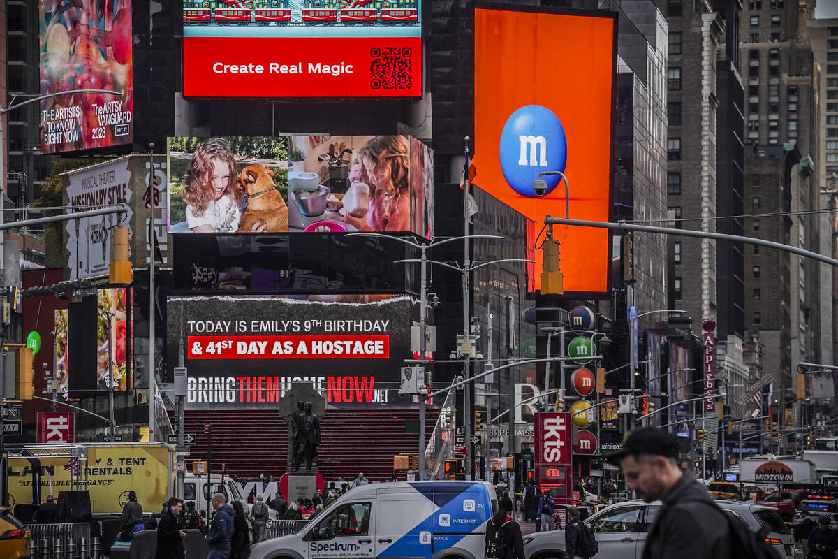 A Times Square billboard displays a poster of Hamas hostage Emily Hand, Friday, Nov. 17, 2023, ...