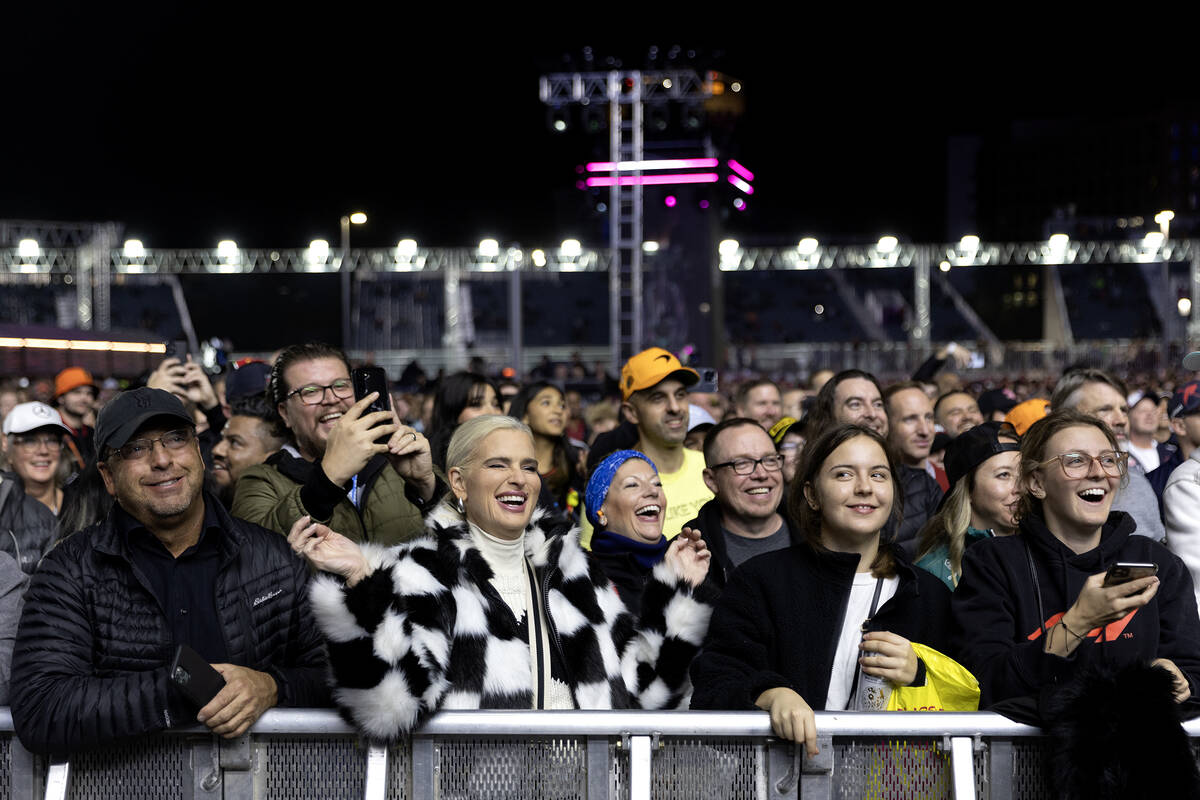 Fans play along with Blue Man Group’s show before the third practice for the Formula One ...