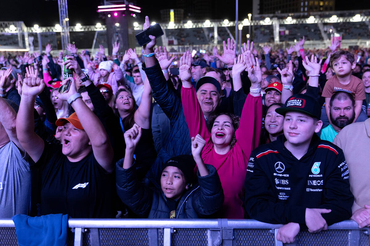 Fans play along with Blue Man Group’s show before the third practice for the Formula One ...