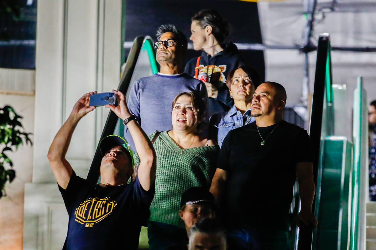 Strip tourists look upon the Formula 1 racetrack prior to the third practice race for the Formu ...