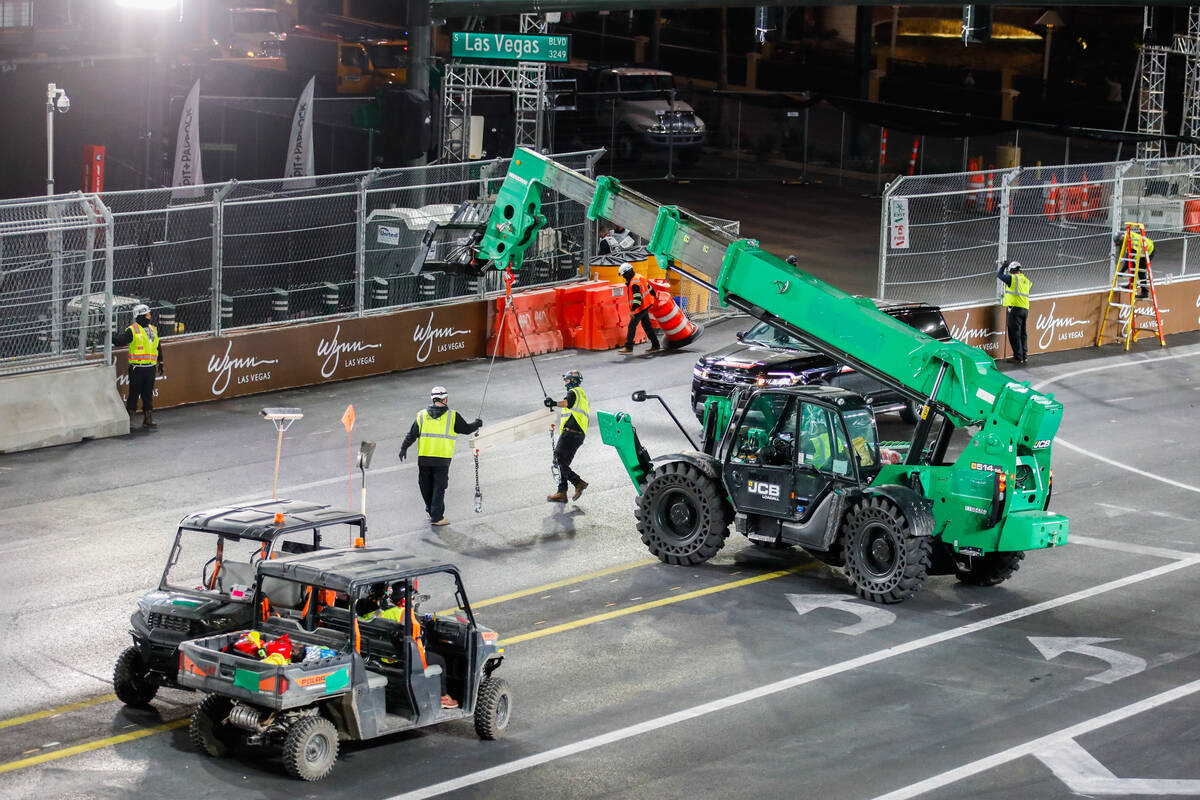 Construction workers put the final touches on the Formula 1 racetrack prior to the third practi ...