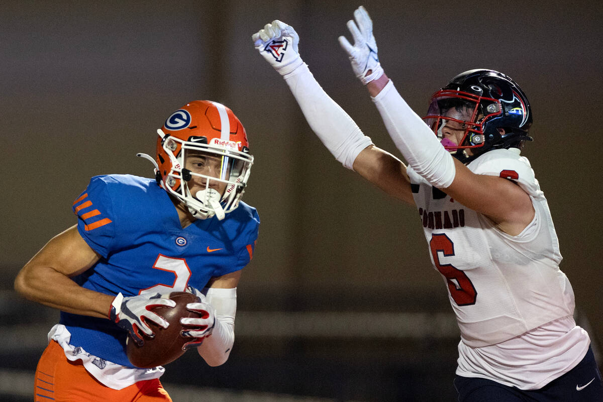 Bishop Gorman wide receiver Audric Harris (2) catches a touchdown pass while Coronado defensive ...