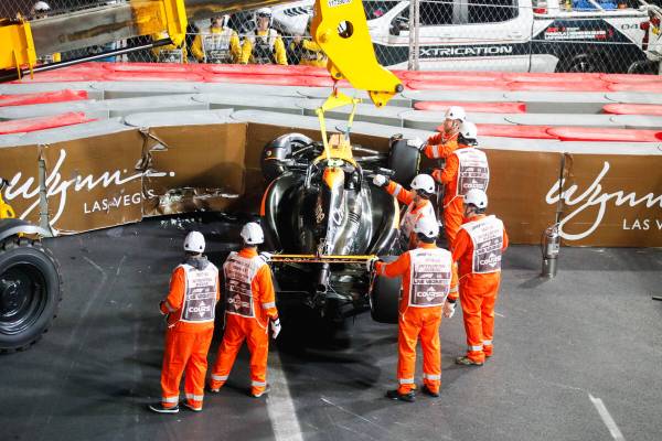 Crews flip the car of McLaren driver Lando Norris after he crashed during the final Formula 1 L ...