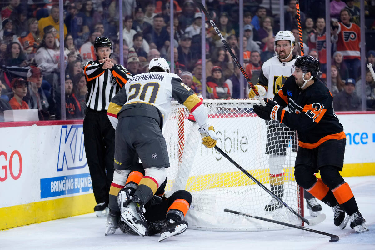 Vegas Golden Knights' Chandler Stephenson (20) collides with Philadelphia Flyers' Garnet Hathaw ...