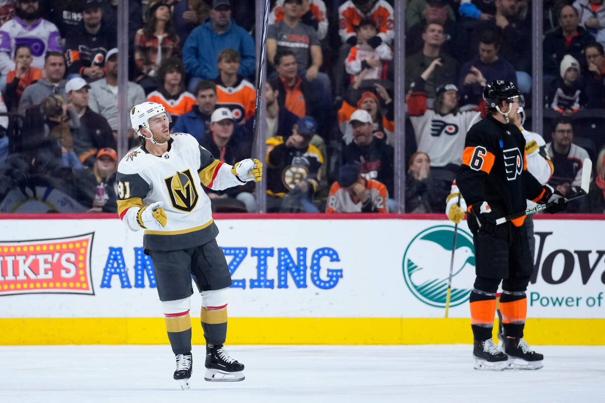 Vegas Golden Knights' Jonathan Marchessault, left, celebrates past Philadelphia Flyers' Travis ...