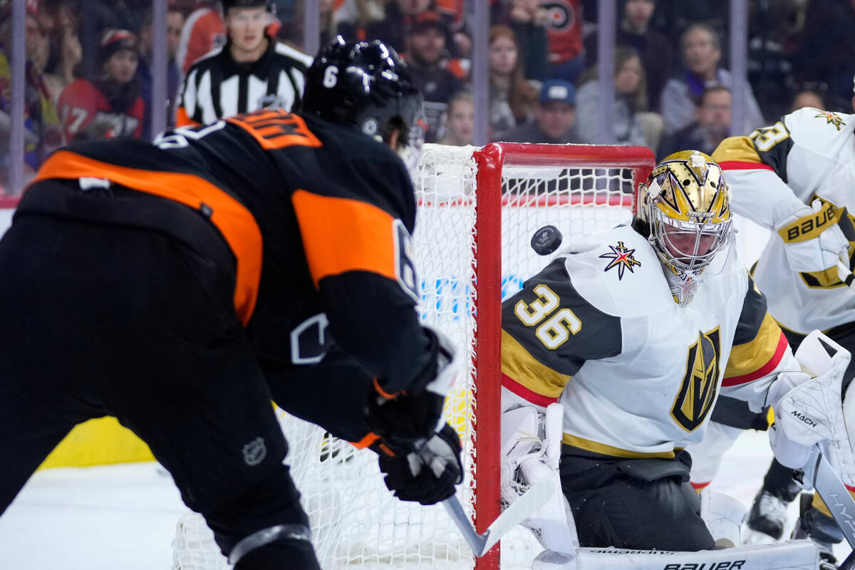 Vegas Golden Knights' Logan Thompson, right, blocks a shot by Philadelphia Flyers' Travis Sanhe ...