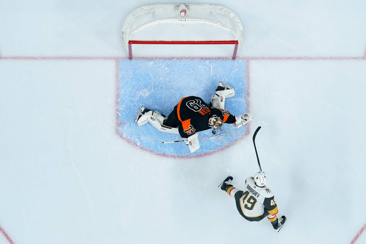 Philadelphia Flyers' Carter Hart, left, blocks a shot by Vegas Golden Knights' Ivan Barbashev d ...