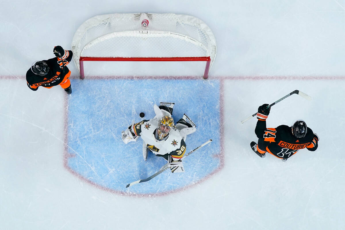 Vegas Golden Knights' Logan Thompson, center, reacts after giving up the game-winning goal to P ...