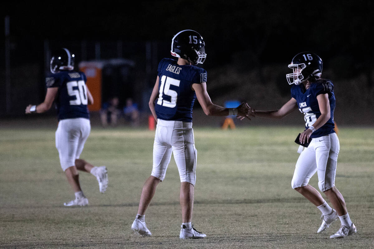 Lake Mead’s Gavin Rhodes and Gracie Rhodes celebrate after their team scored a touchdown ...