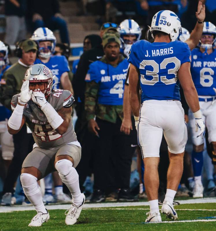 UNLV linebacker Elijah Shelton (42) makes a smell signal at the Air Force student section after ...