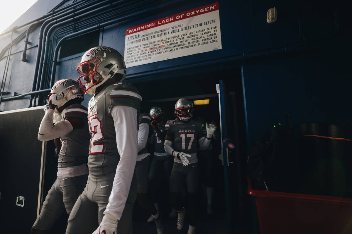 UNLV players take to the field before a game against Air Force at Falcon Stadium on Saturday, N ...