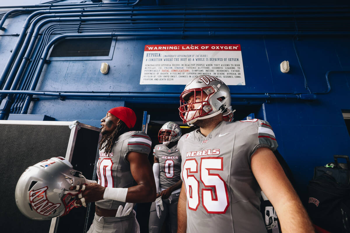 UNLV players take to the field before a game against Air Force at Falcon Stadium on Saturday, N ...