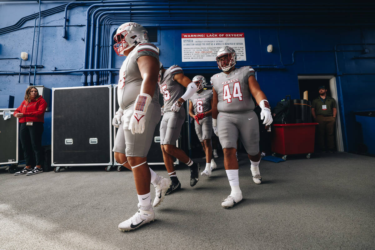 UNLV players take to the field before a game against Air Force at Falcon Stadium on Saturday, N ...