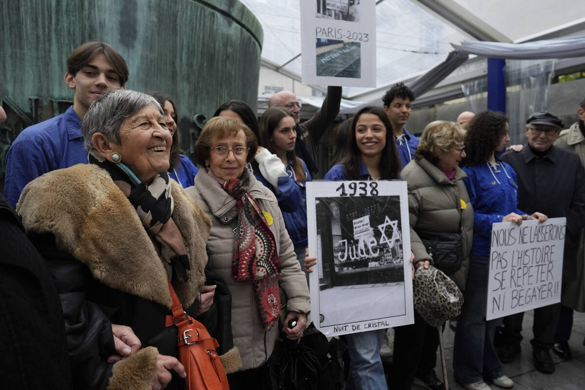 French Holocaust survivor Ginette Kolinka, left, smiles as she attends a gathering in the Paris ...