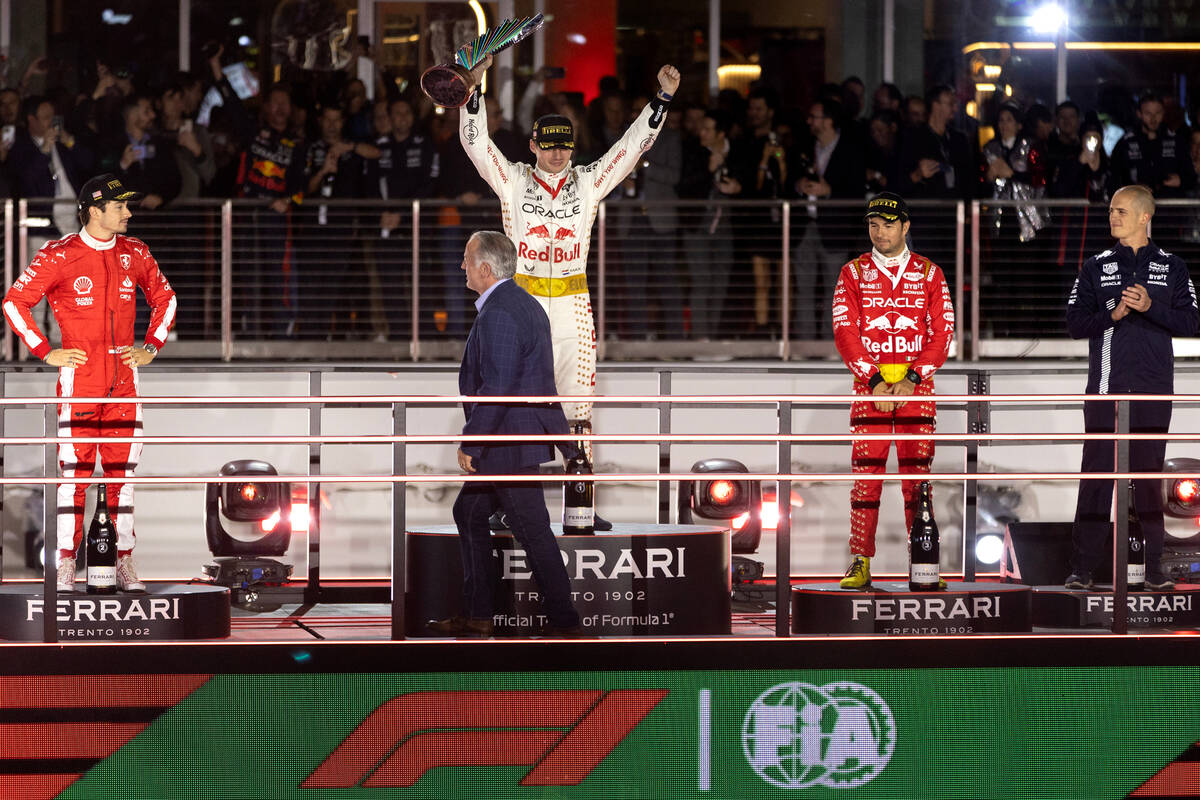 Red Bull Racing driver Max Verstappen holds his first place trophy up alongside his fellow winn ...