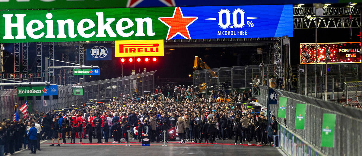 Cars, drivers, crews and guests crowd about the grid before the race start during on the final ...