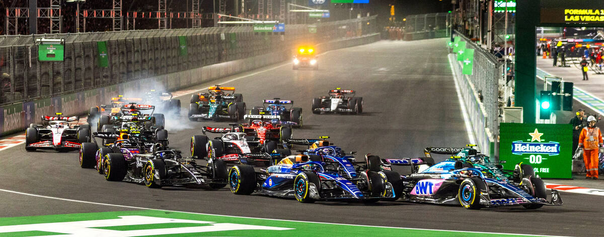 Cars bunch up into turn one at the start of the Las Vegas Grand Prix Formula One race on Saturd ...