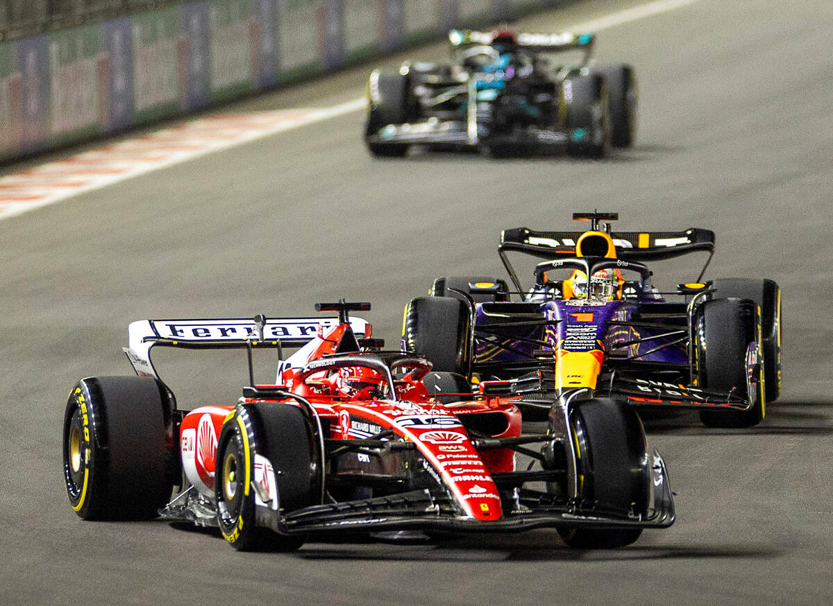 Ferrari driver Charles Leclerc leads Red Bull Racing driver Max Verstappen into turn one during ...